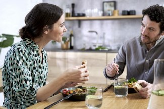 couple sitting on table, having lunch together