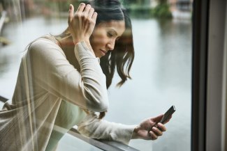 woman is looking on mobilephone display