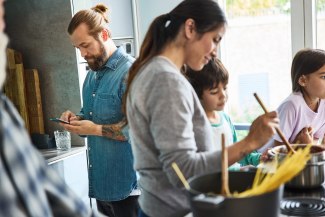 family is cooking together in kitchen