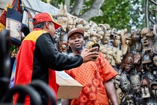 DHL driver picks up a parcel on the African Market