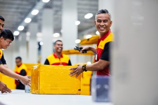 DHL employer sorting out parcels for delivery