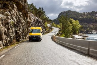 DHL van driving alongside a fjord