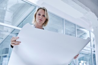 woman looking on architecture plan