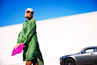 girl with a pink bag in front of a darkblue sky