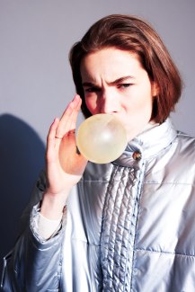 girl with silver snowjacket and bubble