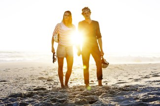 couple standing together at the beach during sunset