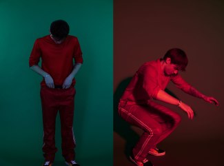 young men in red cloths is jumping in front of a red backdrop