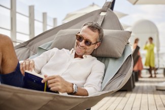 Man in hammock, reading a book