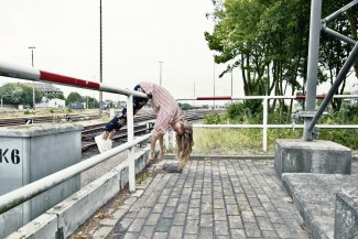young woman hanging over handrail