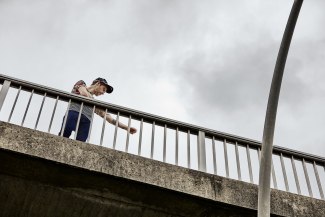 young man standing on bridge