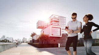 couple with joggingoutfits standing inforont of smart building