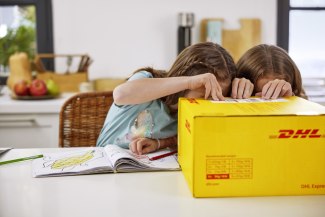 two you girls are peeping into a DHL Parcel