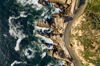 droneshot of a DHL van driving coastal road