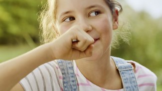 young girl tasting a yoghurt