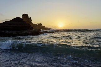sunset into a rough ocean