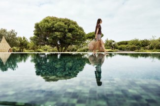 woman walking beside a pool