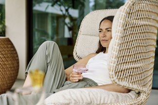 woman sitting in a big white armchair