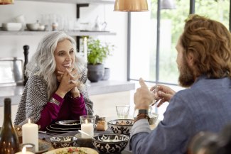 a woman and a man sitting together a the table