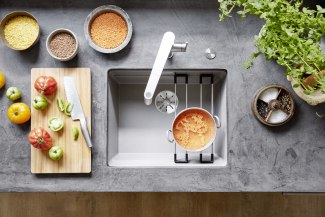 still of a sink and the tap together with vegetables and colorful lentils