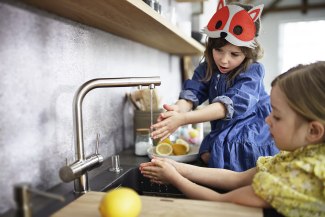 two young girls with a fox-mask washing their hands