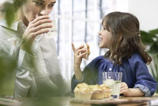 mother a young girls sitting at the table