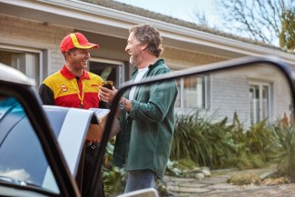DHL driver in conversation with his customer