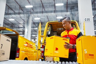 DHL employer sorting out parcels for delivery