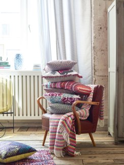a cushionpile on a vintagstyle armchair