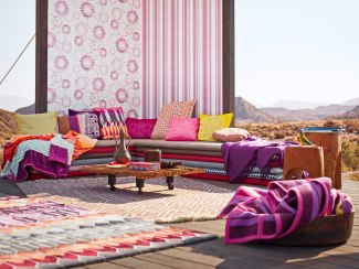 cushions on a bench in a open hut in a desert environment