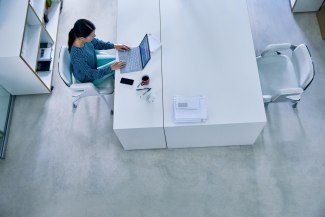 woman working at her desk in office environment, topshot