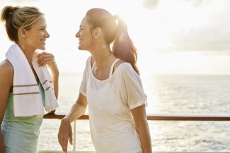 two women in sportswear talking to each other after workout