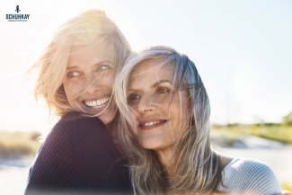 woman and mother face to face close to the beach