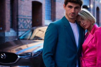 couple standing in front of the car