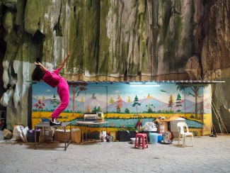 woman in pink jumpsuit dancing on a table