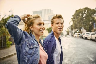 young couple walking through Capetown in drizzle rain