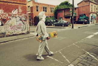 man in a sharkcostume is walking through Melbourne