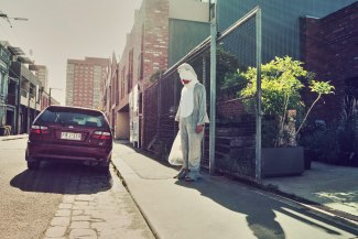 man in a sharkcostume is walking through Melbourne