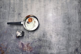 egg sunny-side up in pan on metal ground