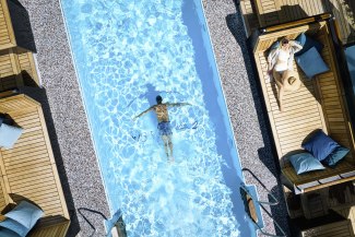 Cruiseship EUROPA 2 young man diving through a pool on a cruiseship