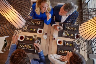 two couples dining together a sushi-dish