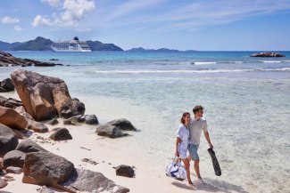 Cruiseship EUROPA 2 young couple strolling at the beach,