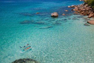 couple snorkeling in the indian ocean, droneshot