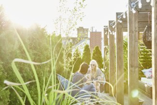 two young women sitting together on roofterrace