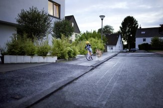 young girl on bicycle, riding on footpath young girl on bicycle, riding on footpath