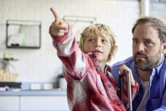 father and son in hotellobby, son pointing somewhere behind the camera