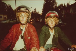 two teenager with helmet on their first motorbikes
